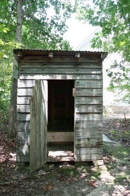 Two seater outhouse behind the church. image. Click for full size.