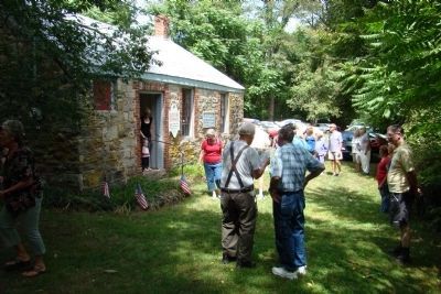 People waiting for their turn to enter Old Stone Schoolhouse Open House. image. Click for full size.