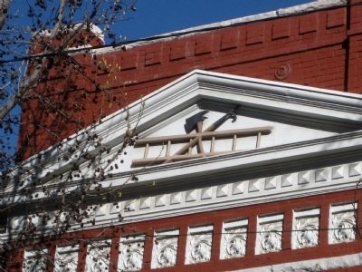 Hook, ax, and ladder - detail of north pediment image. Click for full size.