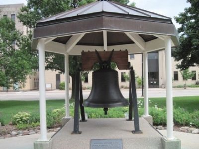Liberty Bell replica located next to statue. image. Click for full size.