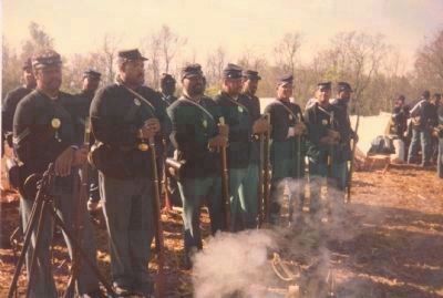 Black Civil War re-enactors from the District of Columbia muster in camp prior to re-staging image. Click for full size.