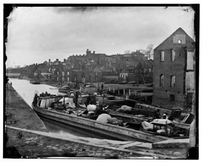 Richmond, Va. Barges with African Americans on the Canal; ruined buildings beyond image. Click for full size.