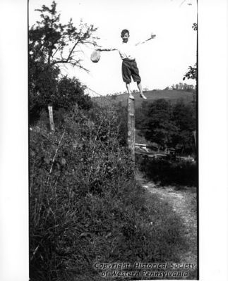 Delvin Miller balancing on a fence post image. Click for full size.
