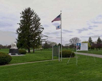 Polar Bear Memorial and Burial Site Marker Underneath U.S. and U.S. Army Flags image. Click for full size.