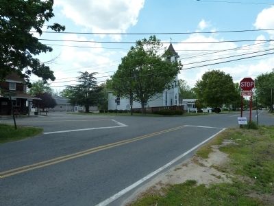 The five-point intersection. The marker can be seen in the distance on the south face of the church. image. Click for full size.