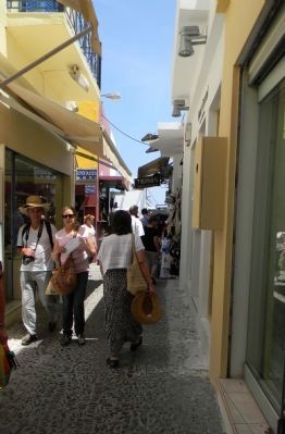 The narrow streets of Fira lead toward the cable car station image. Click for full size.
