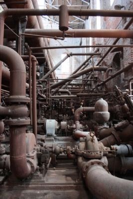 Some of the miles of pipes delivering air, gas and steam throughout the plant. image. Click for full size.