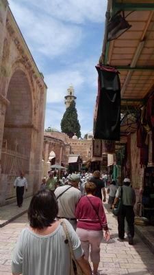 Pilgrims approach the Church of the Holy Sepulchre, navigating by the prominent minaret image. Click for full size.