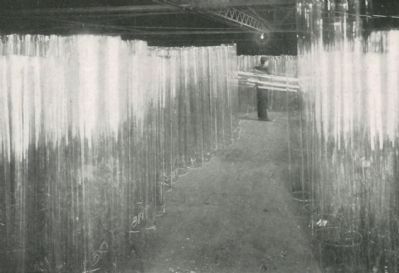 Cylinders of window glass stored ready for flattening image. Click for full size.