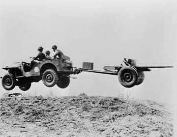 A Bantam "peep car" or "jeep" negotiating rough terrain during test trials for the U.S. Army image. Click for full size.