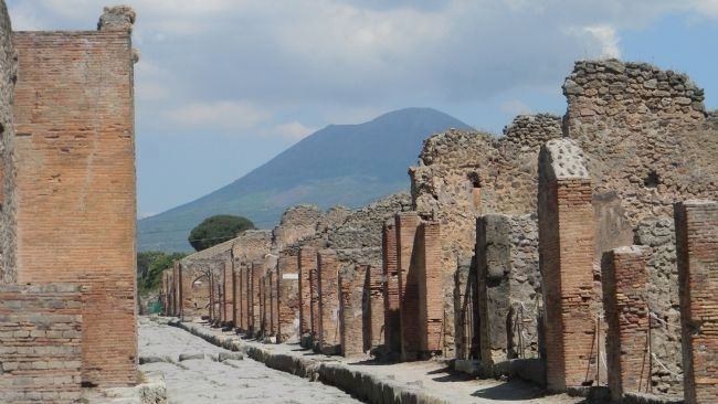 An excavated street near the Forum in Pompeii<br>- Mt. Vesuvius looming five miles to the northwest. image. Click for full size.