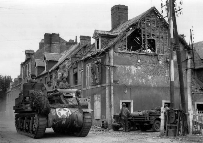 American M7 self-propelled howizer vehicle in Carentan, France, June 1944 image. Click for full size.