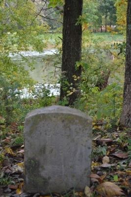 The memorial marker on the river to the Rhodes family image. Click for full size.