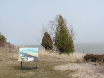 Marker with shoreline in distance. image. Click for full size.