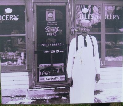 John Hill in front of his grocery store. Click for full size. John Hill in front of his grocery store image. Click for full size.