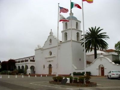 Mission San Luís Rey de Francia & Marker located under the flags. image. Click for full size.