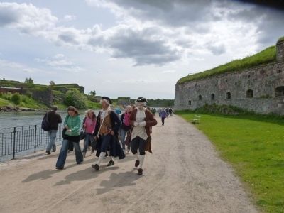 Tourists follow period re-enactors depicting 18th century garrison life in the fortress. Click for full size. Tourists follow period re-enactors depicting 18th century garrison life in the fortress image. Click for full size.