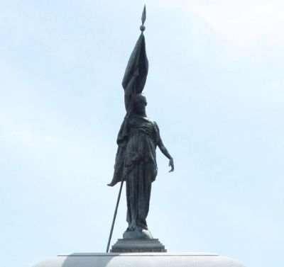 The standing female figure, wearing drapery and holding a partially unfurled flag image. Click for full size.