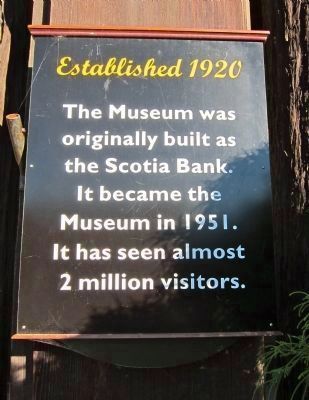 Sign mounted to the right of the museum entrance image. Click for full size.