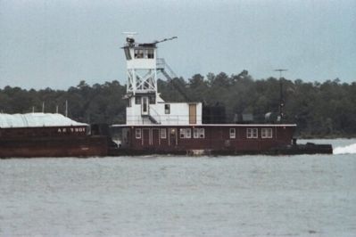 Towboat Pushing A Barge Through The Intra-Coastal Canal In The Orange Beach Area. Click for full size. Towboat Pushing A Barge Through The Intra-Coastal Canal In The Orange Beach Area image. Click for full size.