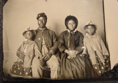 Unidentified African American soldier in Union uniform with wife and two daughters image. Click for full size.
