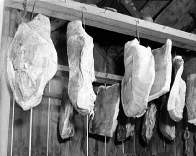 Cured pork hanging in the meat house of a Negro FSA client at Calvert, Maryland image. Click for full size.