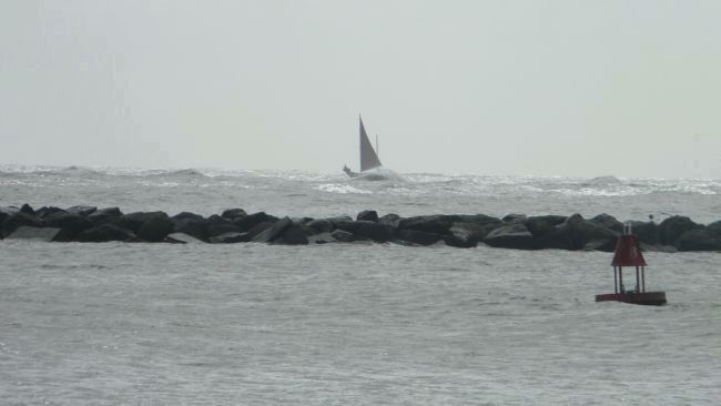 Sailboat in choppy seas, outside the breakwater off Ocean City image. Click for full size.