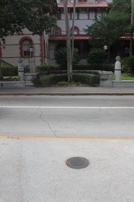 Rosario Redoubt in sidewalk with Flagler College in background image. Click for full size.