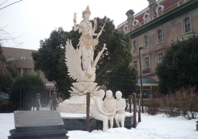 <i>Dewi Saraswati</i> statue, with the Embassy of Indonesia in background image. Click for full size.