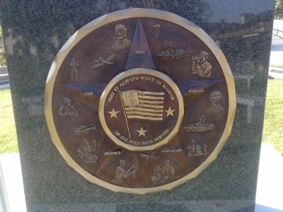 Image of flag on disk honoring the military service branches image. Click for full size.