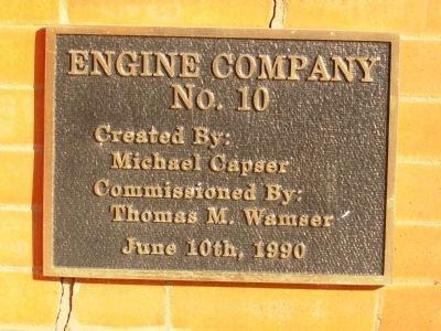 Artist's Plaque above fireman image. Click for full size.