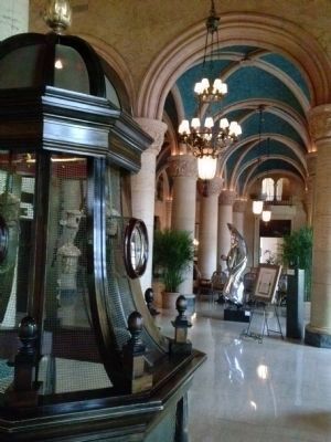 Bird cage, barrel-vaulted ceiling and marble columns in the hotel lobby image. Click for full size.