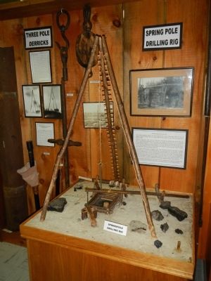 Model of a three-pole, spring-board oil derrick image. Click for full size.