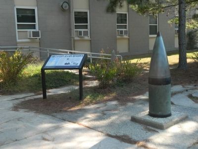 Marker next to 16-inch artillery shell in front of Biden Center image. Click for full size.