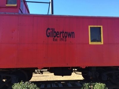 Caboose in Gilbertown near typical oil derrick and pump. image. Click for full size.