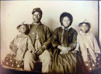 Unidentified African American soldier in Union uniform with wife and two daughters, ca. 1864 image. Click for full size.