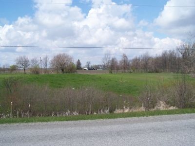 Looking Northwest from the cemetery, one can see the former home of Thomas Stanfield. image. Click for full size.