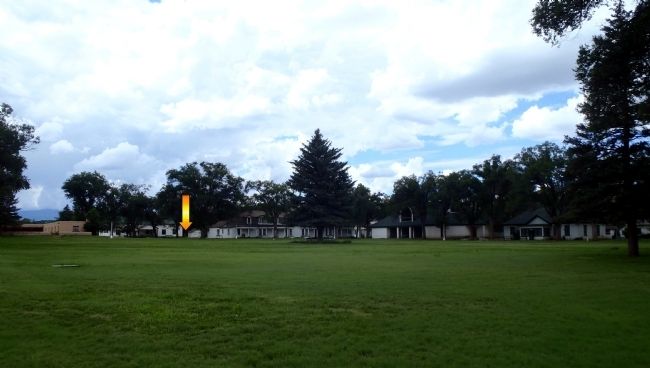 Commissary Warehouse marker [arrow] looking NW from across the parade ground image. Click for full size.