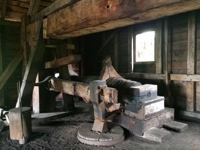 Large water-driven power hammer at the forge. image. Click for full size.