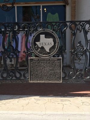 Marker mounted to store railing. image. Click for full size.