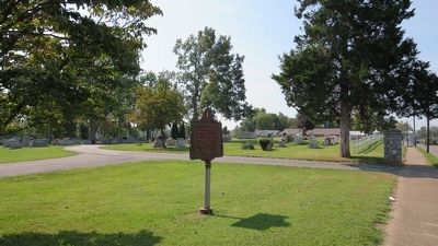 Wide area photo of marker and cemetery graves. image. Click for full size.