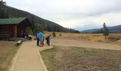 Marker, cabin and homesteaded land image. Click for full size.