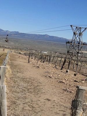 Boot Hill Cemetery - Row of Graves with Ore-bucket Tramway in Background image. Click for full size.