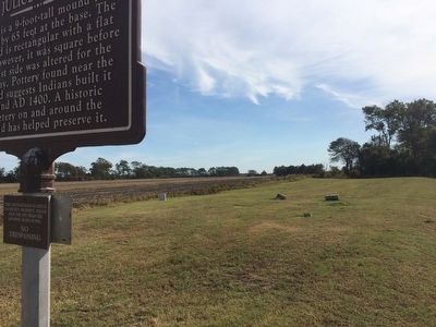 A few grave markers dot the mound. image. Click for full size.