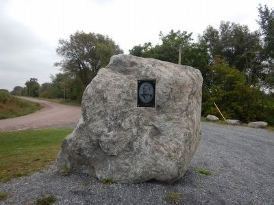 Portrait of Louis Cyr anchored in rock next to marker image. Click for full size.