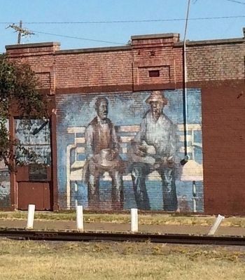 Nearby mural depicting the meeting in 1903 of W.C. Handy & the blues at the railroad depot. image. Click for full size.