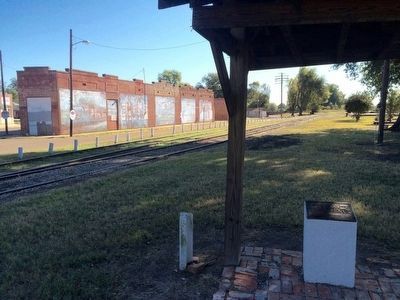Plaque and murals in background. image. Click for full size.