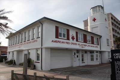 American Red Cross Volunteer Life Saving Corps and Station Marker with building behind image. Click for full size.