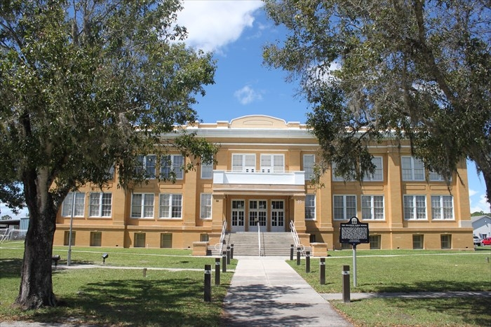 The Fellsmere Public School Marker with school in background