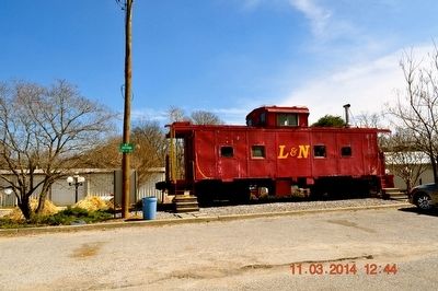 Red Caboose sitting on old train tracks image. Click for full size.